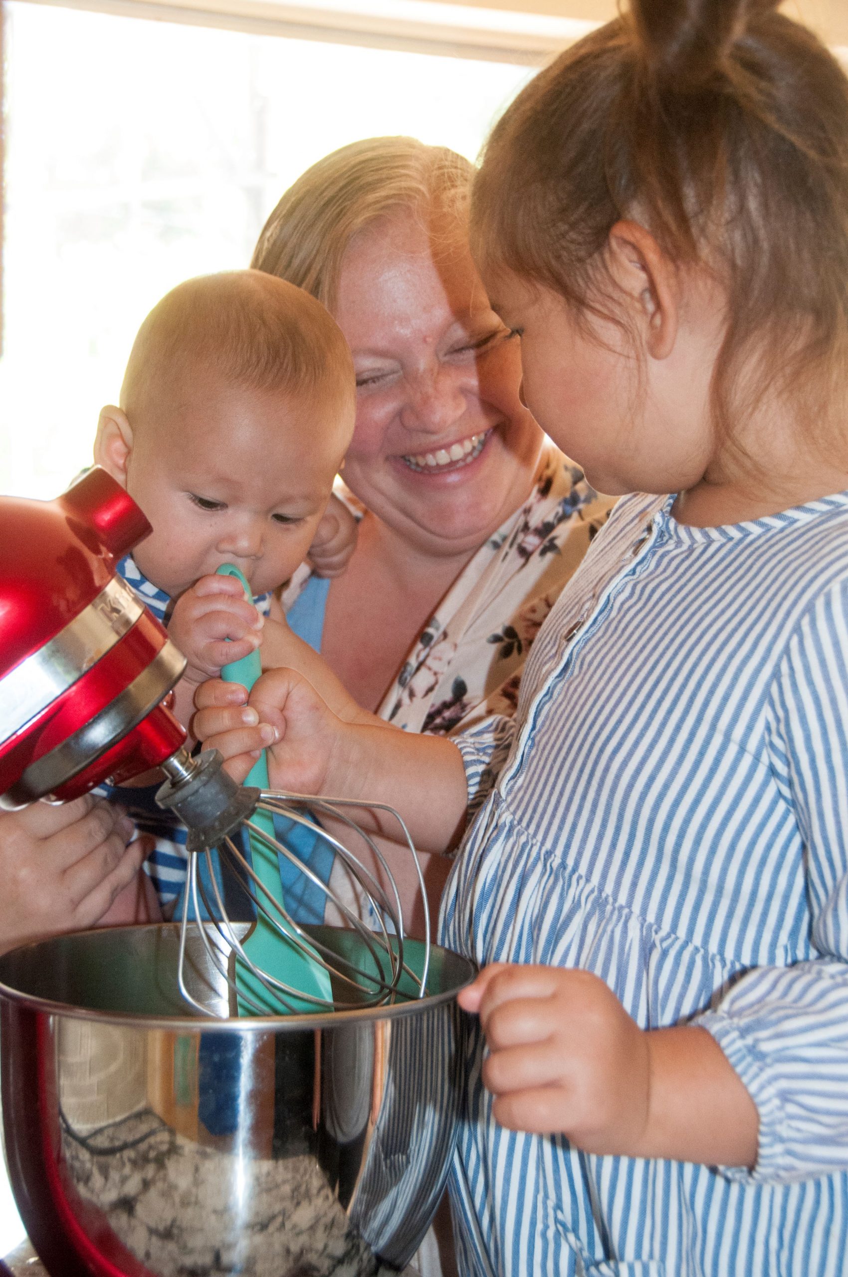 Ally Adair Chung homeschooling with her daughter and baby in the kitchen baking with a stand mixer.
